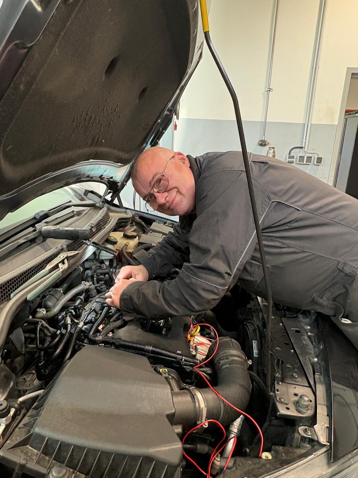 Werkstattmeister Sven Fasting bei der Arbeit am Motor bei Auto Horn in Rastede